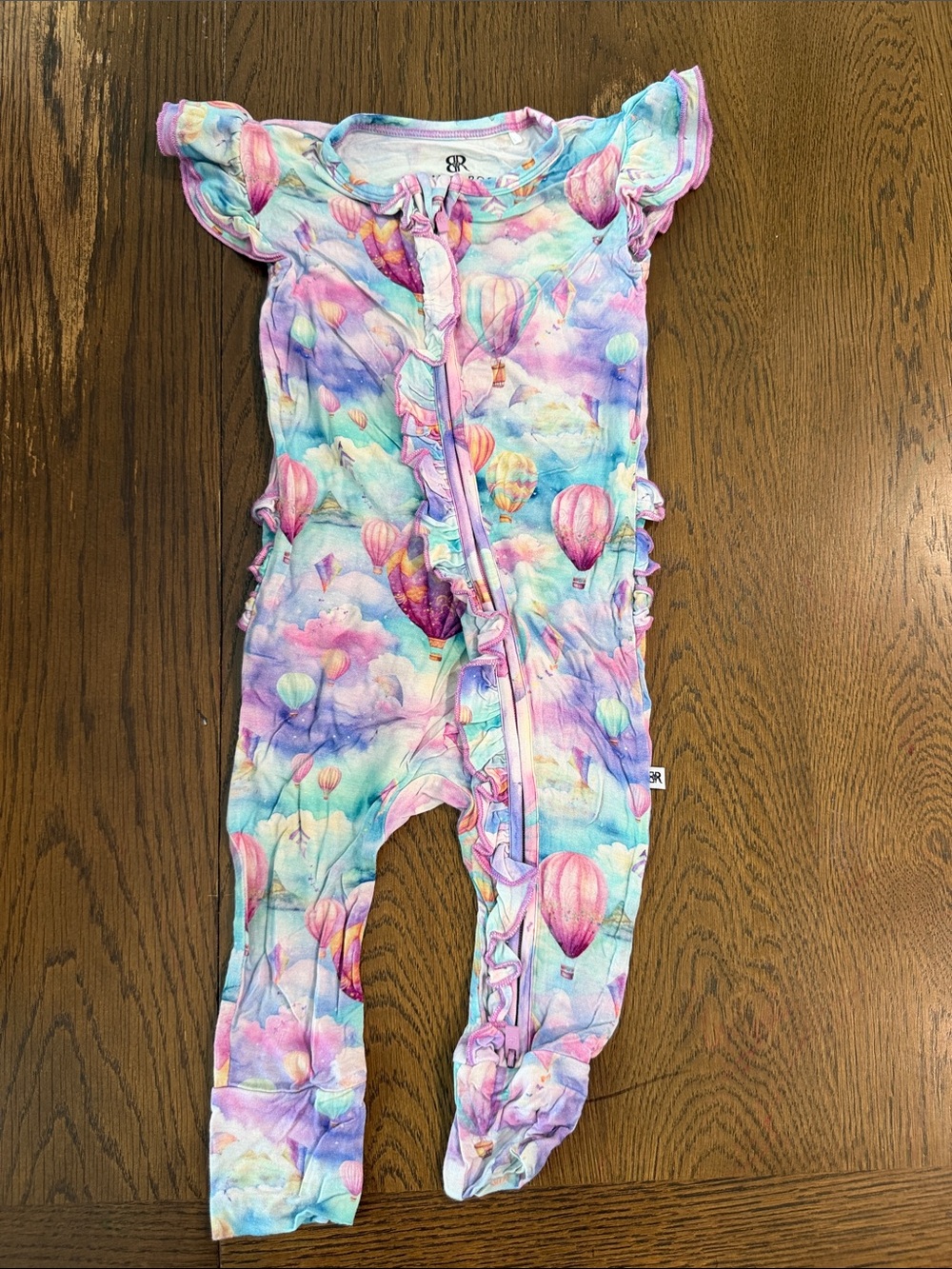 Bums and Roses Bamboo Ruffle Front Zip One-Piece Footie in Pastel Multi - Girls